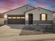 Single-story home with brown garage door and landscaped front yard at 37517 W San Clemente St, Maricopa, AZ 85138