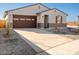 Single-story house with brown garage door and desert landscaping at 37517 W San Clemente St, Maricopa, AZ 85138