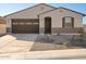 Single story home with brown garage door and neutral color scheme at 37517 W San Clemente St, Maricopa, AZ 85138