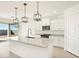 Open concept kitchen with a large island and access to backyard at 37517 W San Clemente St, Maricopa, AZ 85138