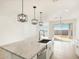 Open kitchen with island, stainless steel appliances, and access to backyard at 37517 W San Clemente St, Maricopa, AZ 85138