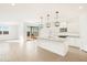 Modern kitchen with white cabinets, island, and stainless steel appliances at 37517 W San Clemente St, Maricopa, AZ 85138