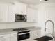 Modern kitchen with stainless steel appliances and white cabinetry at 37517 W San Clemente St, Maricopa, AZ 85138
