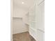 Spacious walk-in closet with built-in shelving at 37517 W San Clemente St, Maricopa, AZ 85138