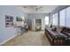 Bright bedroom with a daybed, work area, and neutral colored walls and carpet at 16561 S 179Th Ln, Goodyear, AZ 85338