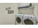 Clean laundry room with washer, dryer, and shelving at 16561 S 179Th Ln, Goodyear, AZ 85338