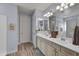 Double vanity bathroom with light colored cabinets and a large mirror at 16561 S 179Th Ln, Goodyear, AZ 85338