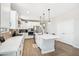 Modern kitchen with white cabinets, large island, and stainless steel appliances at 862 S 172Nd Ave, Goodyear, AZ 85338