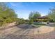 Landscaped backyard with a gazebo and gravel pathway at 7617 E Presidio St, Mesa, AZ 85207