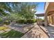 Landscaped backyard oasis with fire pit and pergola at 7617 E Presidio St, Mesa, AZ 85207