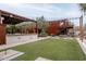Large backyard with artificial turf, outdoor games, and a covered patio at 21423 S 147Th St, Gilbert, AZ 85298