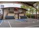 Covered outdoor basketball court with seating and scoreboard at 21423 S 147Th St, Gilbert, AZ 85298
