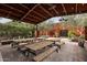 Rustic patio with multiple picnic tables and string lights at 21423 S 147Th St, Gilbert, AZ 85298
