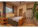 Rustic bedroom with a unique wood bed frame at 21423 S 147Th St, Gilbert, AZ 85298