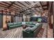 Large living area with a green sectional sofa and hardwood floors at 21423 S 147Th St, Gilbert, AZ 85298