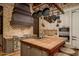 Rustic kitchen with a large island, exposed beams, and pot rack at 21423 S 147Th St, Gilbert, AZ 85298