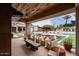 Covered patio with seating area, offering views of the pool and backyard at 21423 S 147Th St, Gilbert, AZ 85298