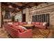 Spacious living room with a large sectional sofa and access to the backyard at 21423 S 147Th St, Gilbert, AZ 85298