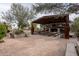 Rustic outdoor kitchen and dining area with a fireplace at 21423 S 147Th St, Gilbert, AZ 85298