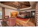 Main bedroom with wood ceiling, large bed, and sitting area at 21423 S 147Th St, Gilbert, AZ 85298
