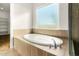 Oval soaking tub with a large window and separate shower at 5309 N 148Th Ave, Litchfield Park, AZ 85340