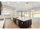 Large kitchen island with dark cabinets and white countertops at 5309 N 148Th Ave, Litchfield Park, AZ 85340