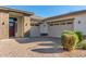 Two-car garage and front entry of this beautiful home with brick accents at 5309 N 148Th Ave, Litchfield Park, AZ 85340