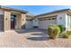 Two-car garage and front entry of this beautiful home with brick accents at 5309 N 148Th Ave, Litchfield Park, AZ 85340