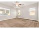 Bright bedroom with carpeted floors and ceiling fan at 5309 N 148Th Ave, Litchfield Park, AZ 85340