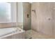 Walk-in shower with neutral tile and glass enclosure at 5309 N 148Th Ave, Litchfield Park, AZ 85340