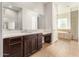 Bathroom with double vanity and a view into the shower and tub at 5309 N 148Th Ave, Litchfield Park, AZ 85340