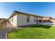 Single story house with grassy backyard and gravel at 5309 N 148Th Ave, Litchfield Park, AZ 85340