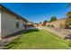 House exterior with grassy backyard and stone wall at 5309 N 148Th Ave, Litchfield Park, AZ 85340