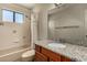 Bathroom with granite countertop, wood cabinets and shower/tub at 6034 E Hillview St, Mesa, AZ 85205