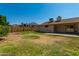 Large backyard with grassy area and partial view of house at 6034 E Hillview St, Mesa, AZ 85205