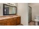 Bathroom with wood vanity, marble countertop, and shower at 6034 E Hillview St, Mesa, AZ 85205