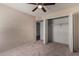 Bedroom with gray carpet, ceiling fan and walk-in closet at 6034 E Hillview St, Mesa, AZ 85205