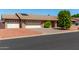Brick ranch house with two-car garage and solar panels at 6034 E Hillview St, Mesa, AZ 85205