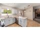 Kitchen with white cabinets, stainless steel appliances, and an island at 6034 E Hillview St, Mesa, AZ 85205