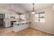 Eat-in kitchen with white cabinets, tile floor and island at 6034 E Hillview St, Mesa, AZ 85205