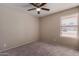 Simple bedroom with gray carpet, window blinds, and ceiling fan at 6034 E Hillview St, Mesa, AZ 85205
