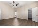 Bedroom with wood-look floors, ceiling fan, and walk-in closet at 6034 E Hillview St, Mesa, AZ 85205