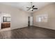 Primary bedroom with wood-look floors, ceiling fan and walk-in closet at 6034 E Hillview St, Mesa, AZ 85205