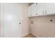 Bright laundry room with white cabinets and tile floor at 6034 E Hillview St, Mesa, AZ 85205