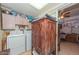 Convenient laundry area with washer, dryer, and storage cabinet at 3002 W Latham St, Phoenix, AZ 85009