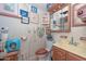 Small bathroom with wood vanity and decorative wall art at 3002 W Latham St, Phoenix, AZ 85009