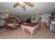 Spacious game room with a pool table and dining area at 3002 W Latham St, Phoenix, AZ 85009