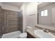 Clean bathroom with shower/tub combo, vanity, and updated tile at 7422 W Turney Ave, Phoenix, AZ 85033