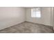 Simple bedroom with tiled floors and a window at 7422 W Turney Ave, Phoenix, AZ 85033