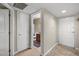 Clean and bright hallway with tiled floors and access to the bathroom at 2025 E Campbell Ave # 260, Phoenix, AZ 85016